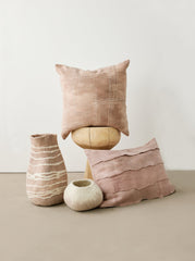 Decorative pillows and vases on a neutral background