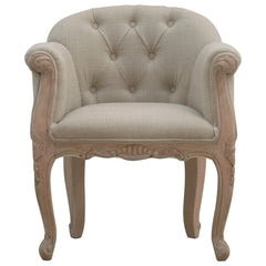 Beige armchair with tufted backrest on a white background