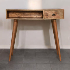 Wooden console table with two drawers on a gray tiled floor against a white wall.