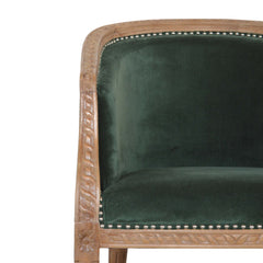 Chair with green velvet seat and backrest and wooden frame on a white background