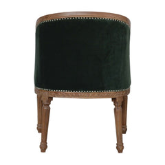 Green velvet chair with wooden legs on a white background