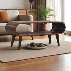 Wooden coffee table in a living room setting with a sofa and plant.