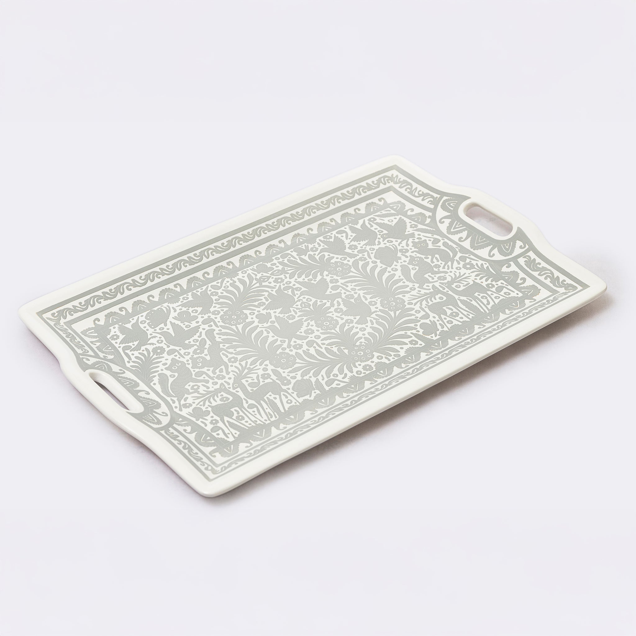 Rectangular cutting board with decorative patterns on a white background