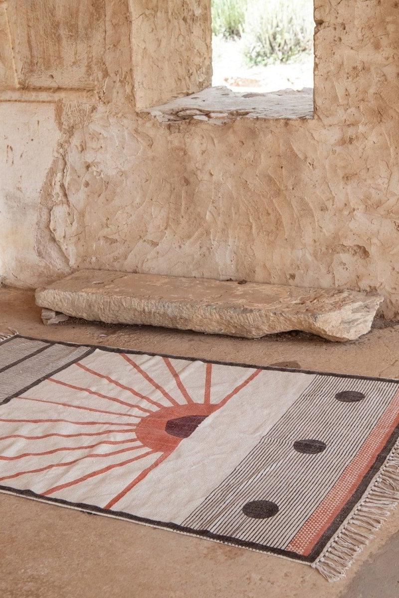 Textile with geometric pattern on a stone floor