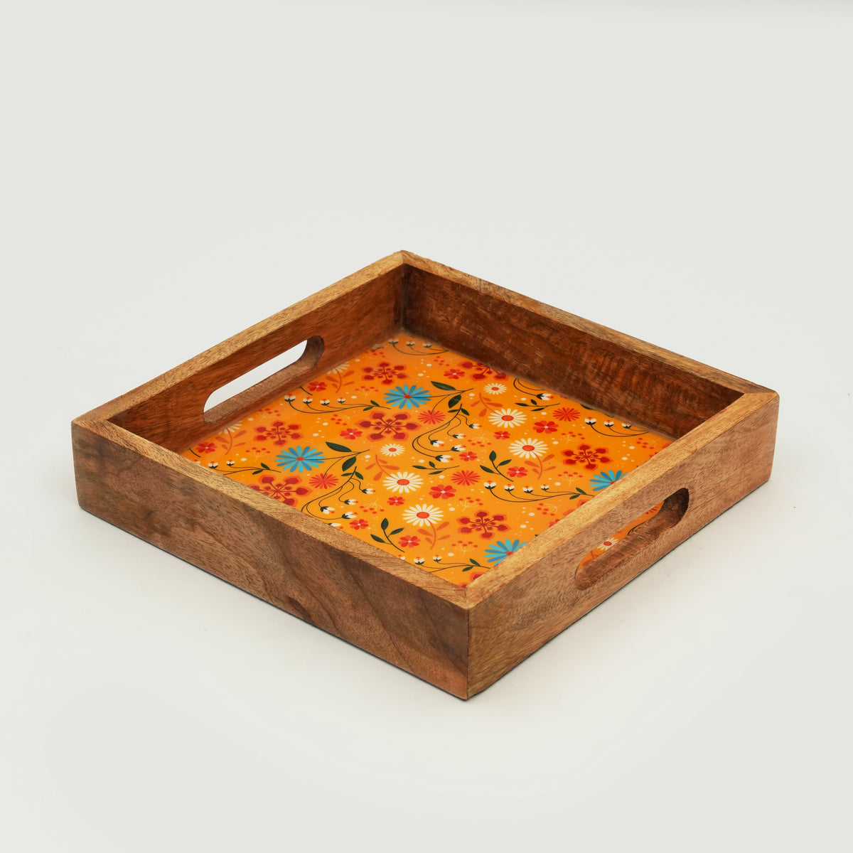 Wooden tray with floral design on an orange background