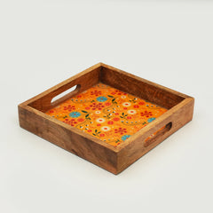 Wooden tray with floral design on an orange background