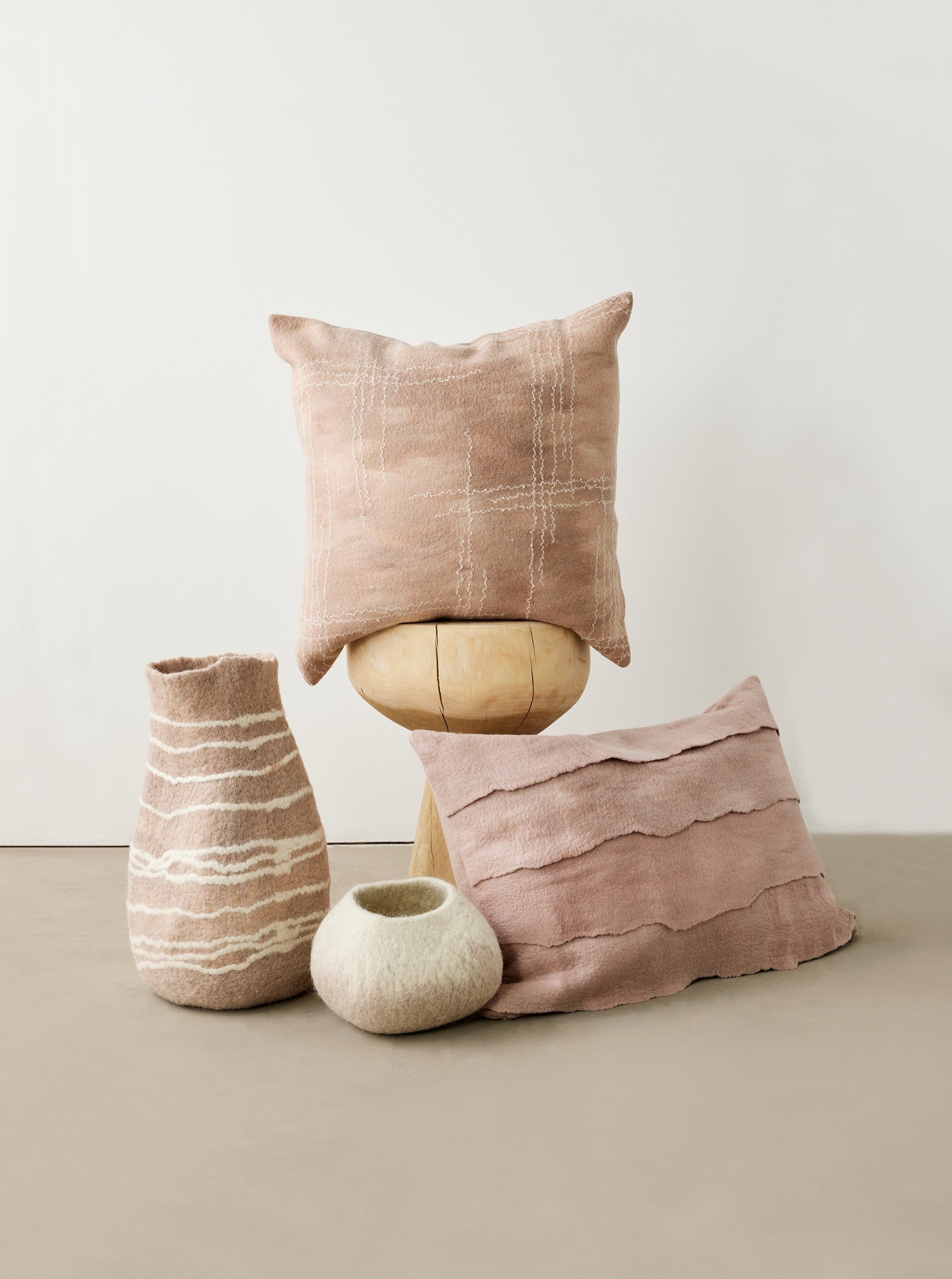 Decorative pillows and vases on a neutral background