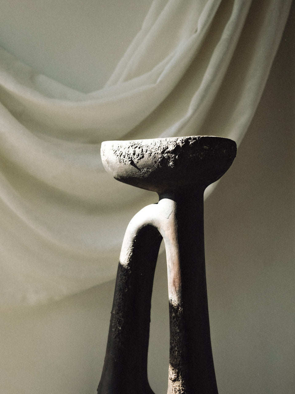 Decorative candle holder with a draped fabric background