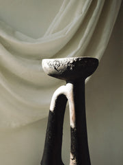Decorative candle holder with a draped fabric background