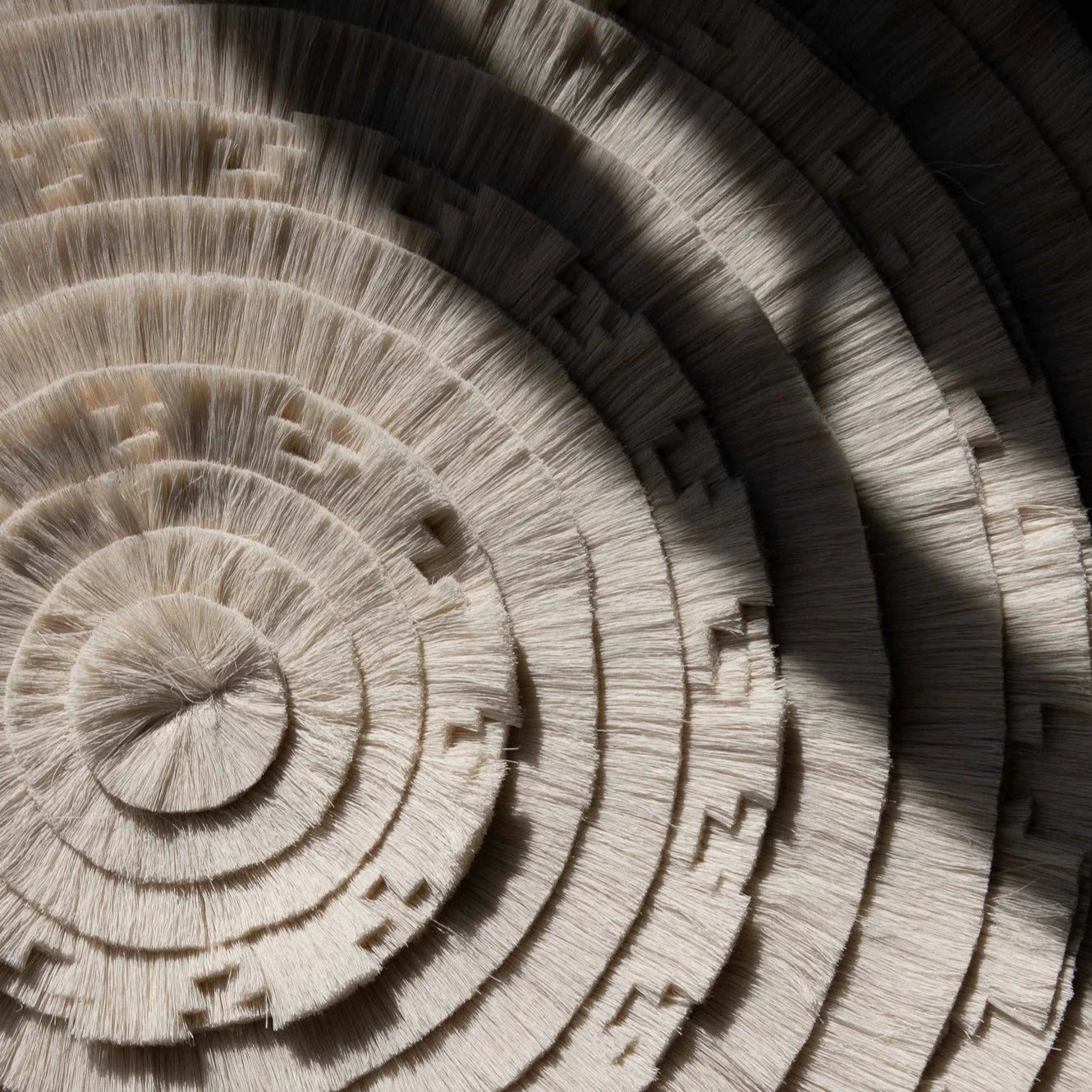 Close-up of stacked wooden discs with concentric circular patterns