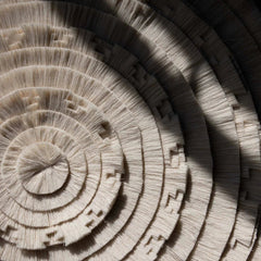 Close-up of stacked wooden discs with concentric circular patterns