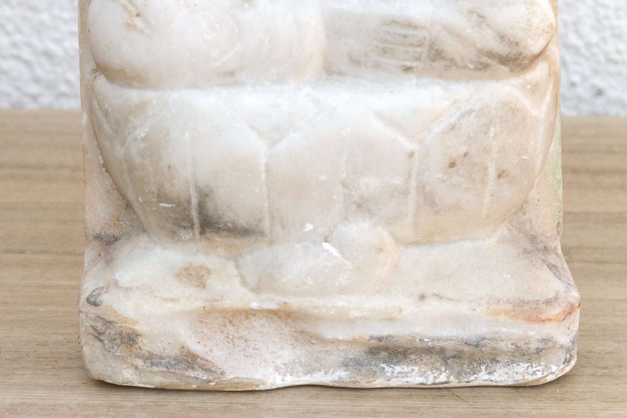 Marble-like textured object on a wooden surface