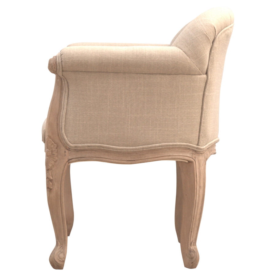 Beige armchair with decorative wooden frame on a white background