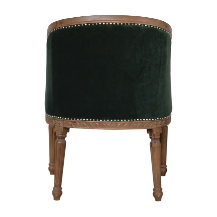 Green velvet chair with wooden legs on a white background