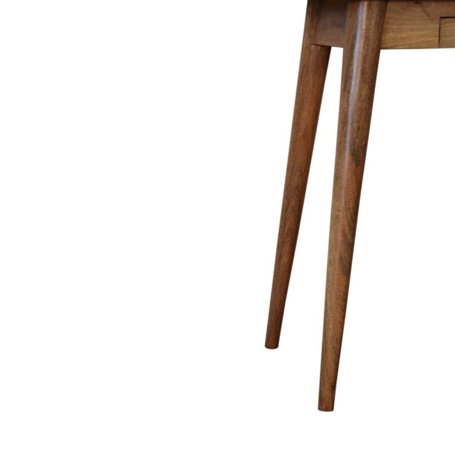 Close-up of a wooden chair leg on a white background