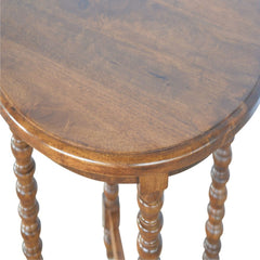 Wooden round table with spindle legs on a white background