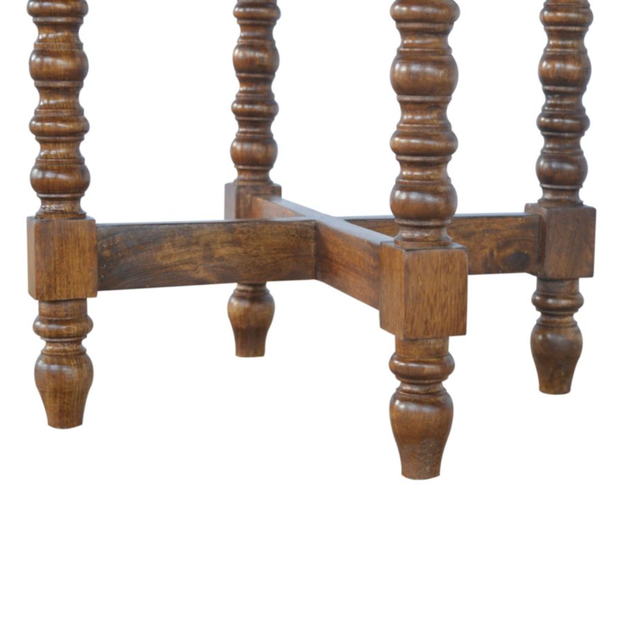 Close-up of a wooden bed frame with spindle design on a white background