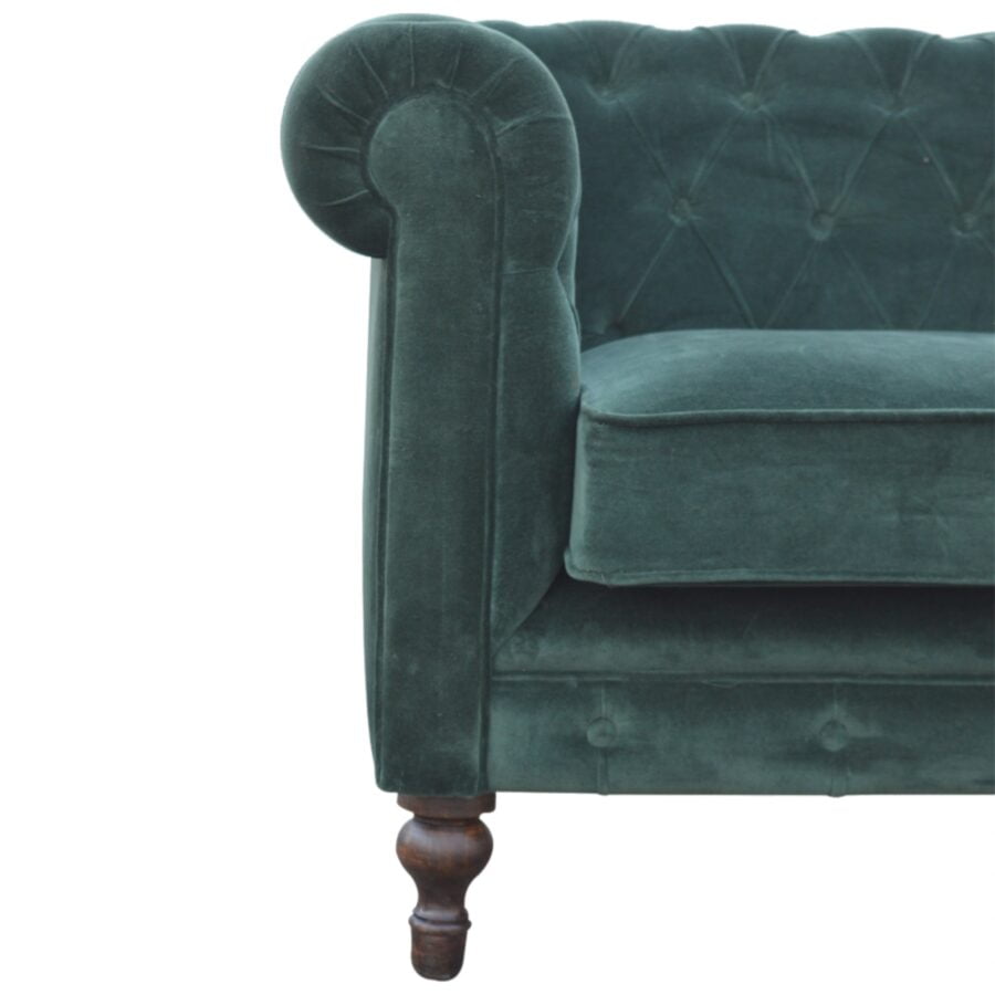 Green velvet sofa with wooden legs on a white background