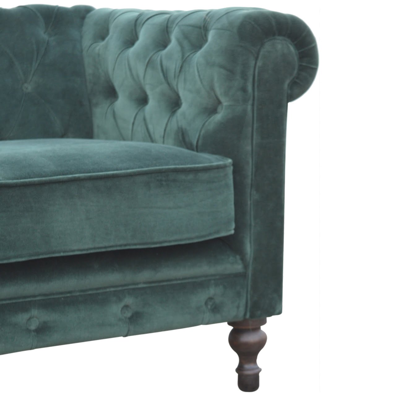 Green velvet sofa with tufted backrest on a white background
