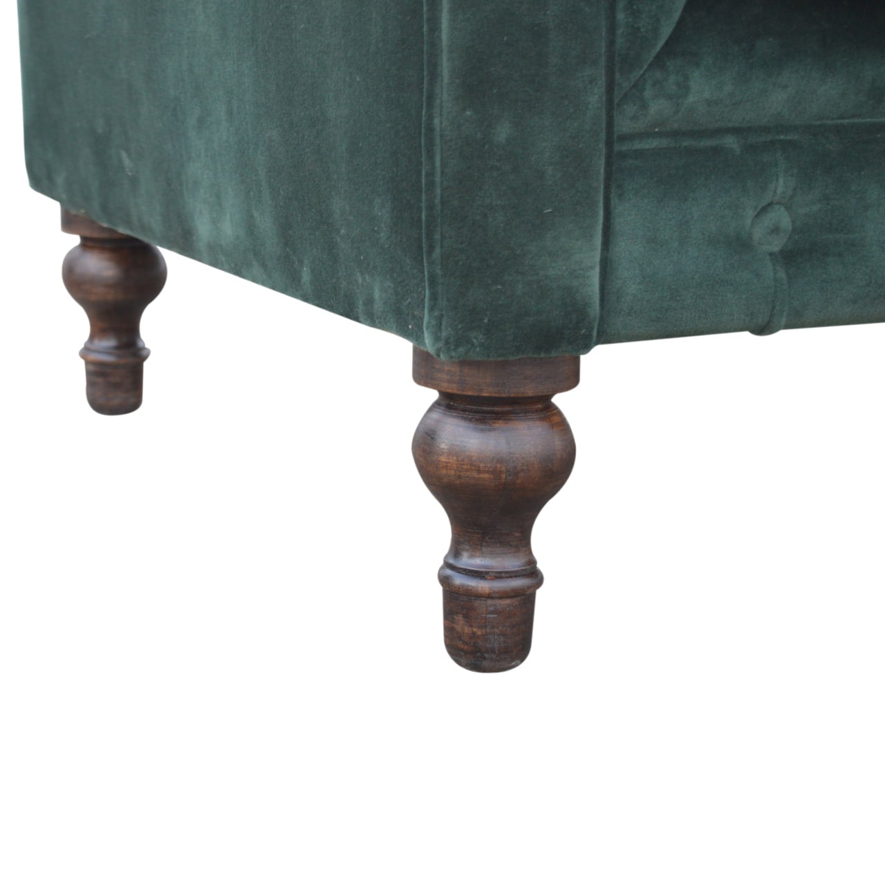 Green velvet armchair with wooden legs on a white background