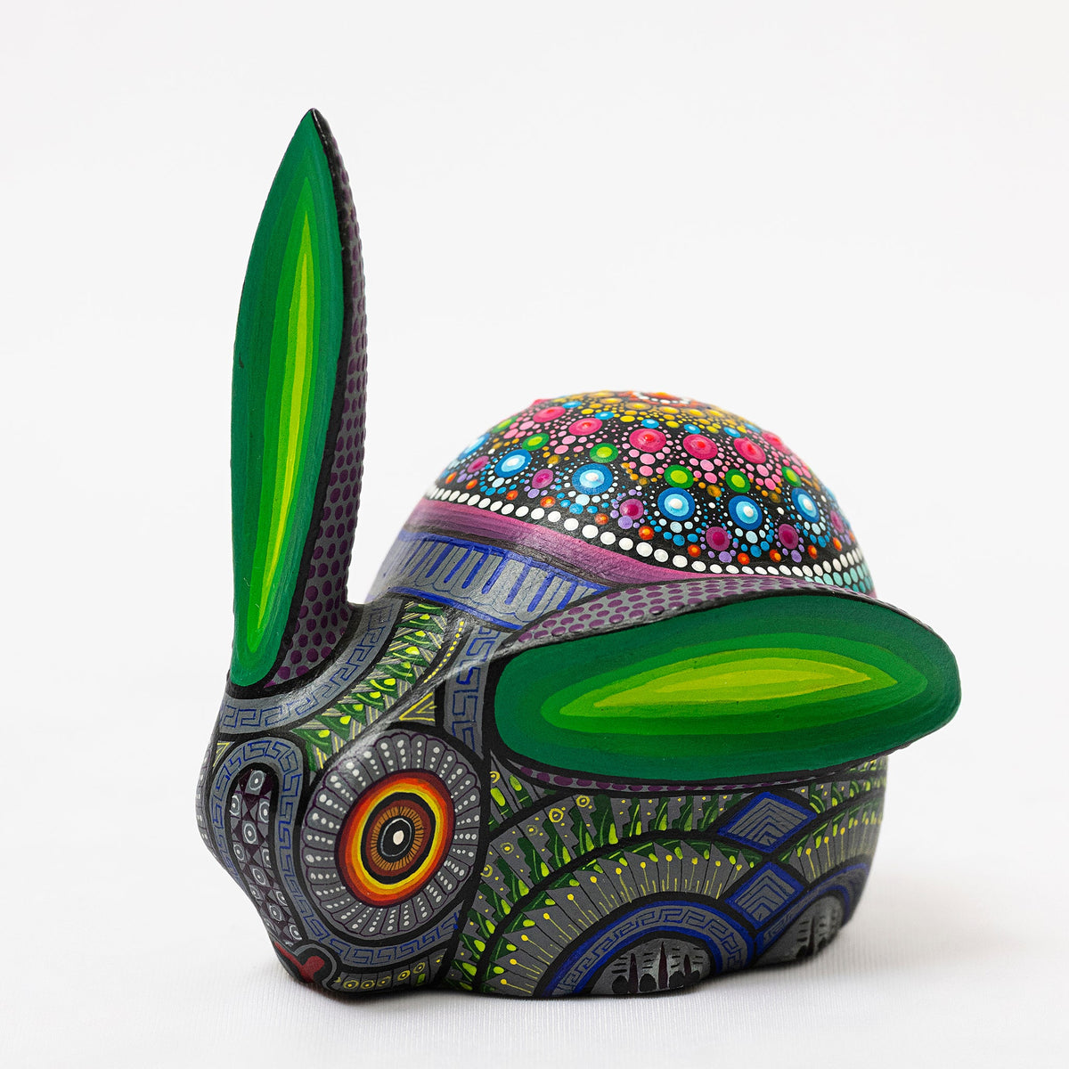 Colorful ceramic rabbit sculpture with intricate patterns on a white background