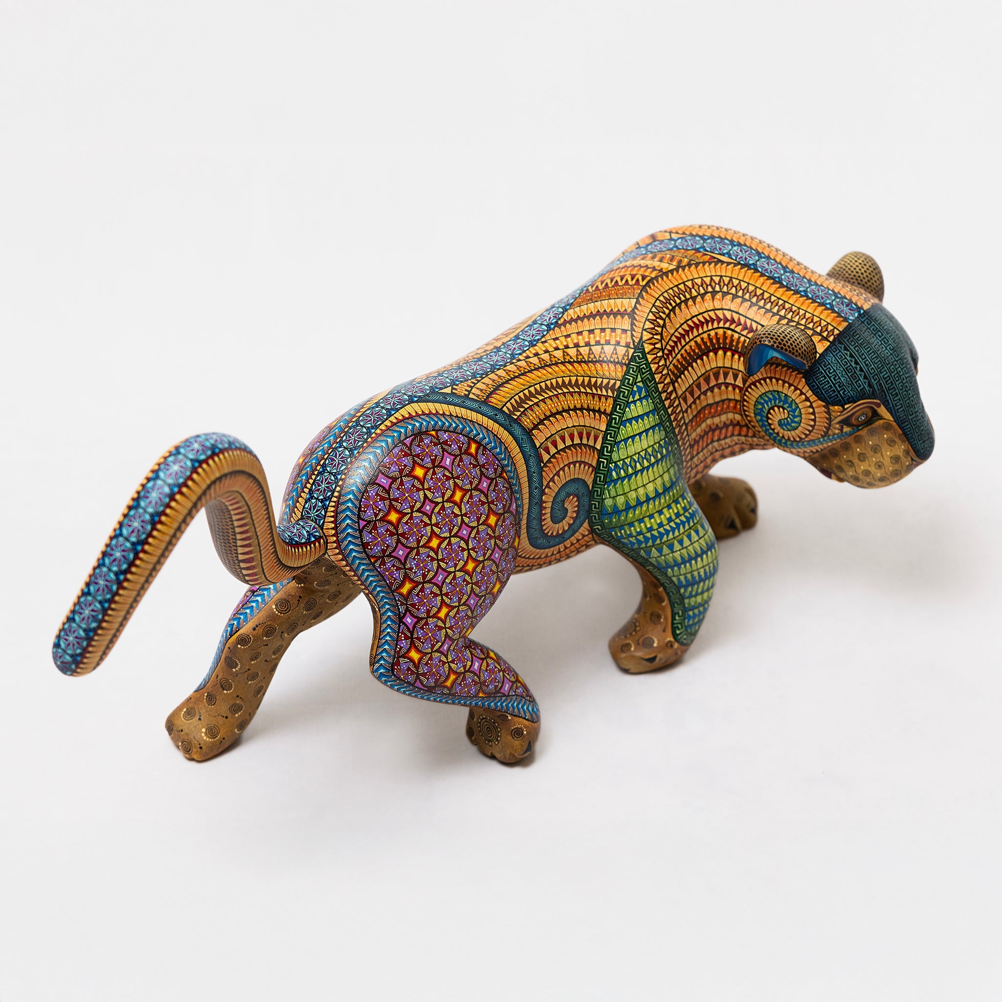 Colorful animal figurine with intricate patterns on a white background
