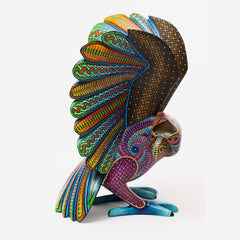 Colorful owl figurine with intricate patterns on a white background