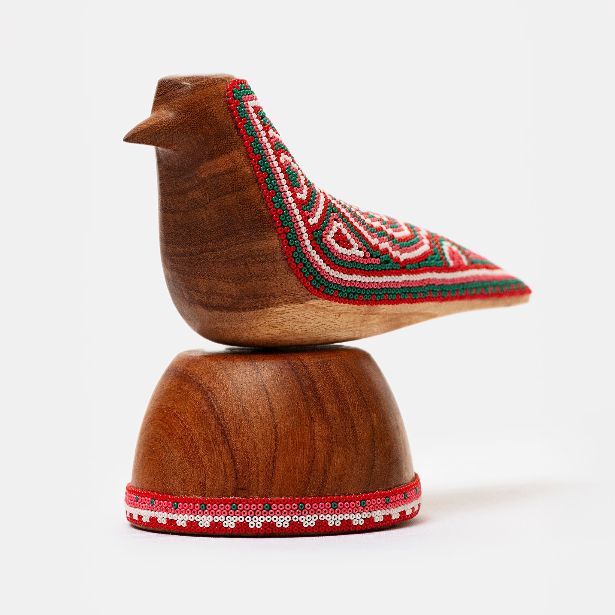 Wooden bird figurine with embroidered details on a white background