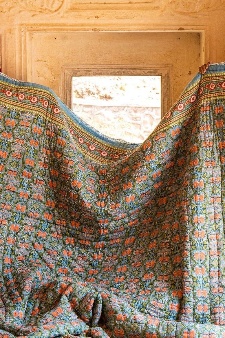 Floral patterned fabric draped over a wooden surface