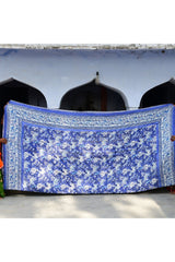Blue floral-patterned fabric draped over a structure with arched windows.