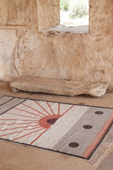 Textile with geometric pattern on a stone floor